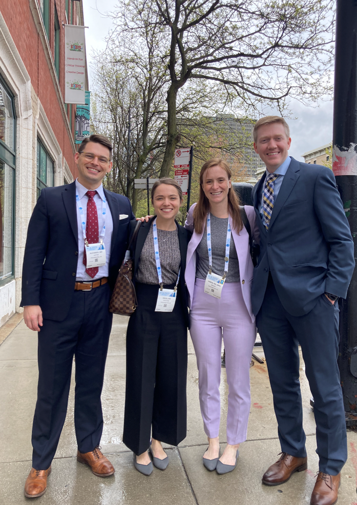 Group of research fellows standing out on the sidewalk