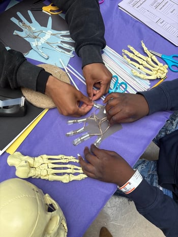 Children participate in a hands-on science learning activity at Children’s National Hospital in Washington D.C., April 29, 2025. The activity appears to replicate real healthcare scenarios. 