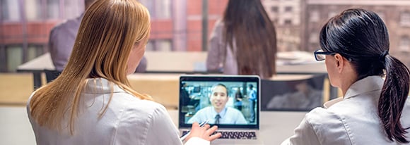 Three colleagues engaged in a web conference