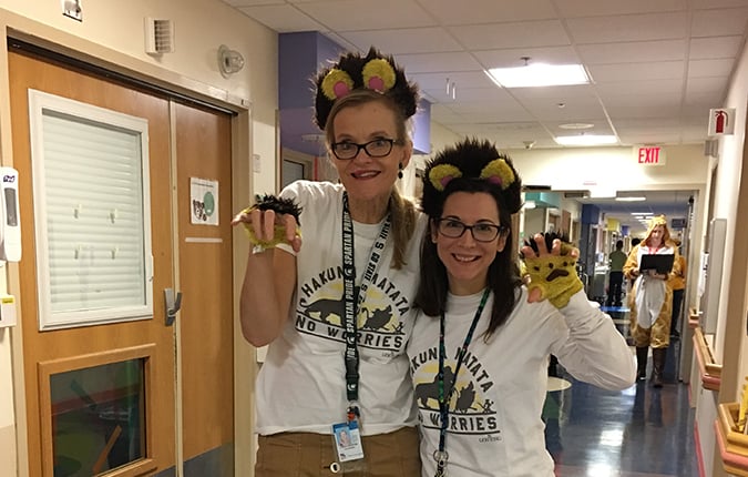 Ms. Leslie and colleague dressed up as lions during a costume event