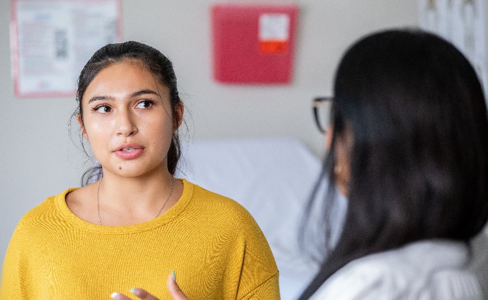 Patient talks with doctor in office