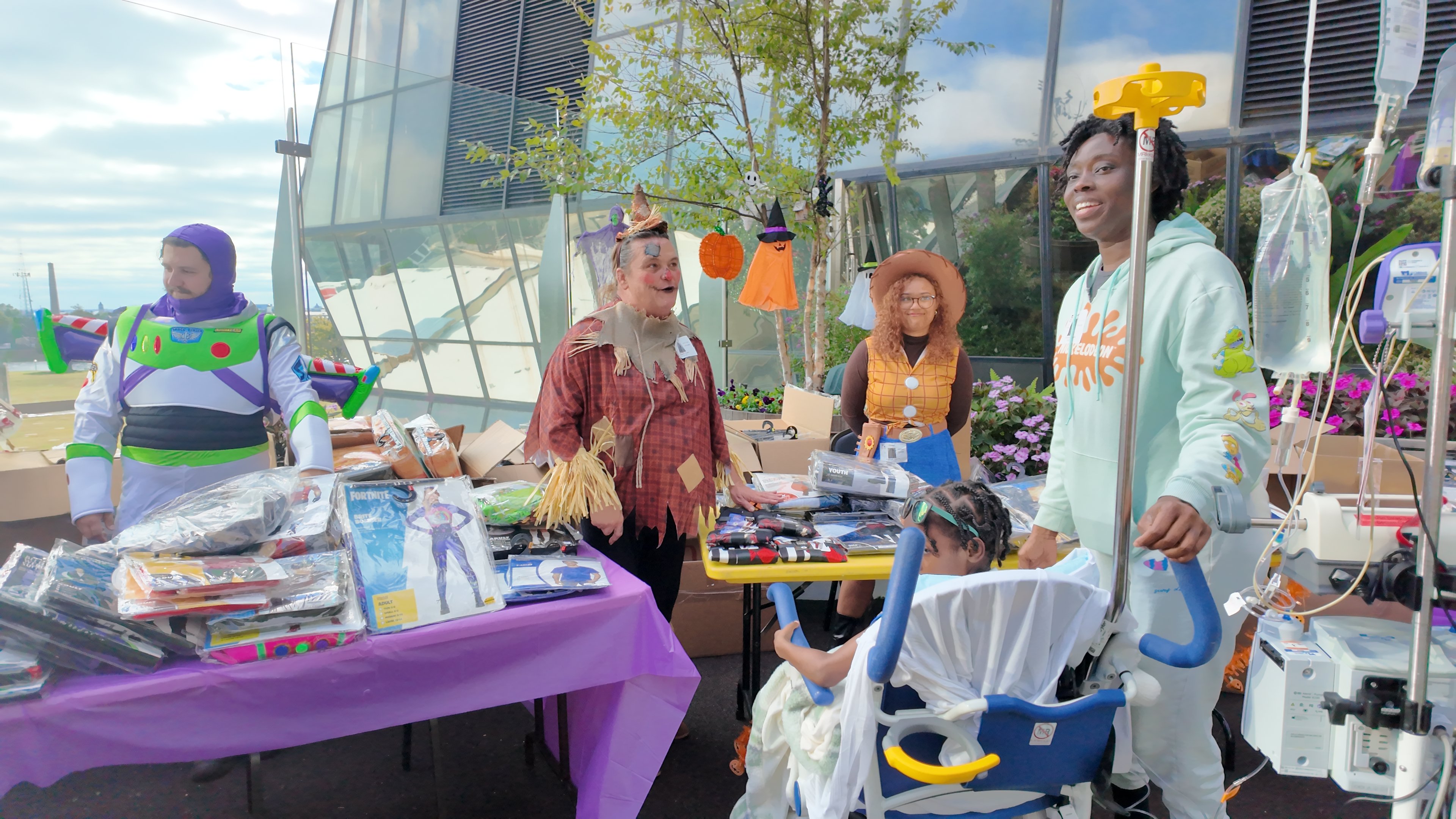 Volunteers dressed in costumes collect and disperse Halloween costumes to patients and families.