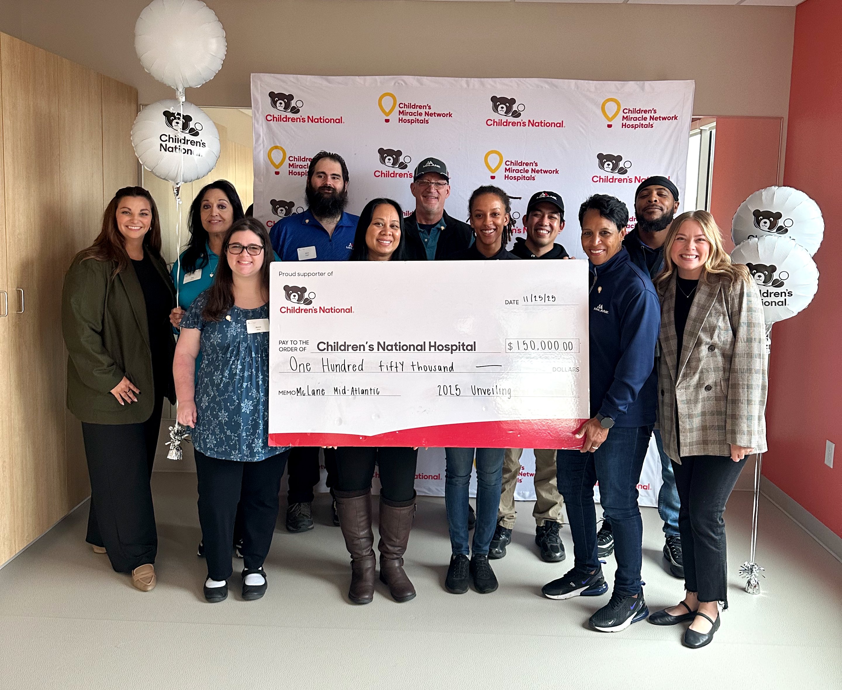 McLane Mid-Atlantic team presents donation check to Children's National Hospital.