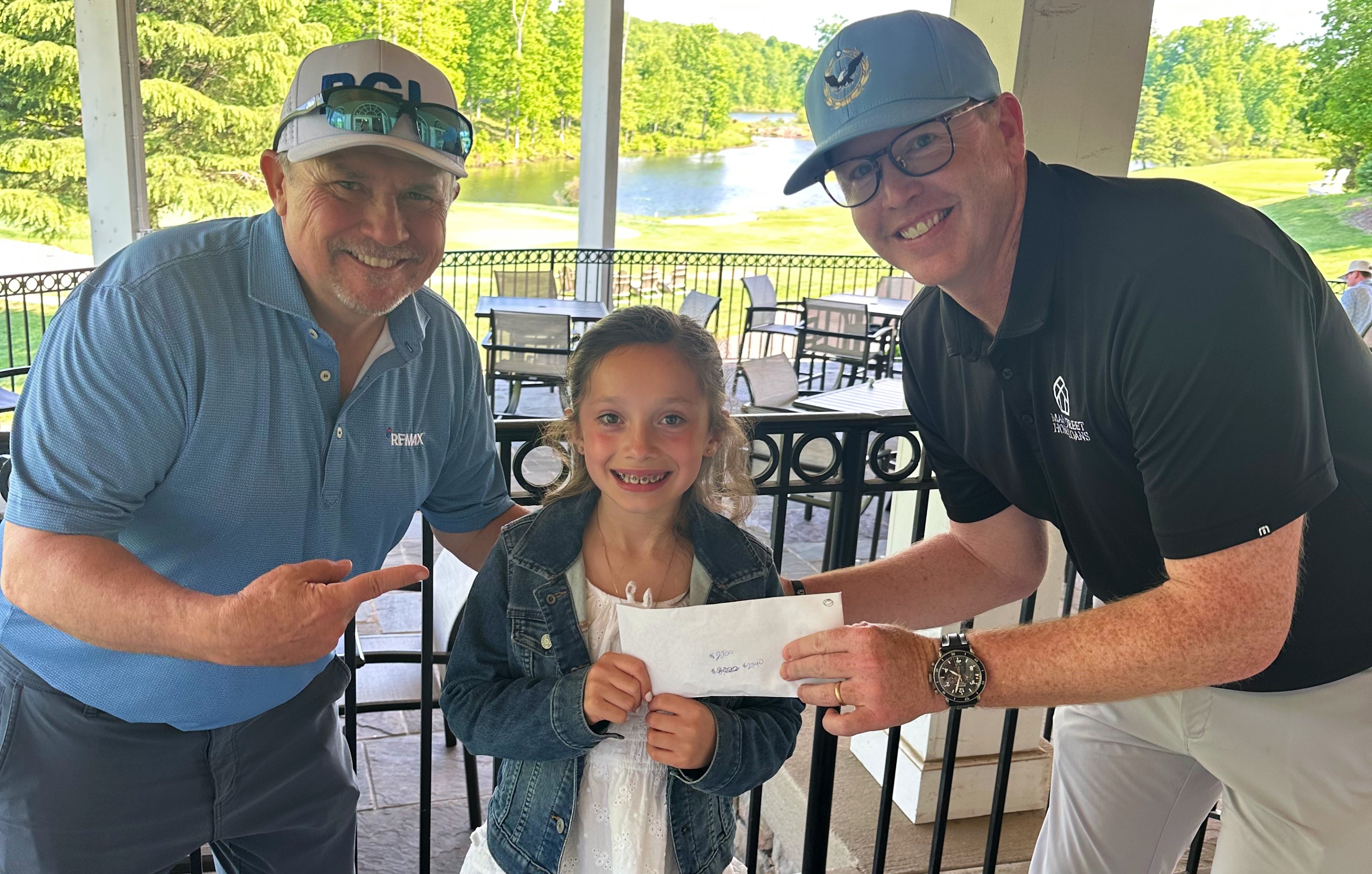 RE/MAX Gateway representatives donate proceeds from their charity golf tournament benefiting Children's National.