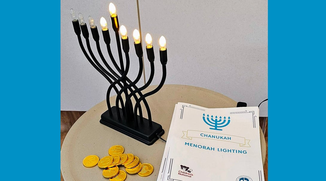An electric menorah alongside several chocolate gold coins