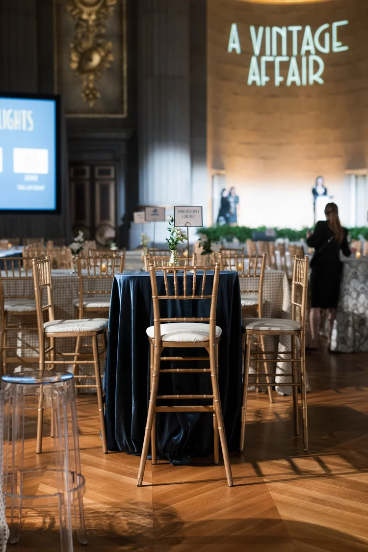 Tables and chairs decorated for the A Vintage Affair 2025 event at the Mellon Auditorium in Washington, D.C.