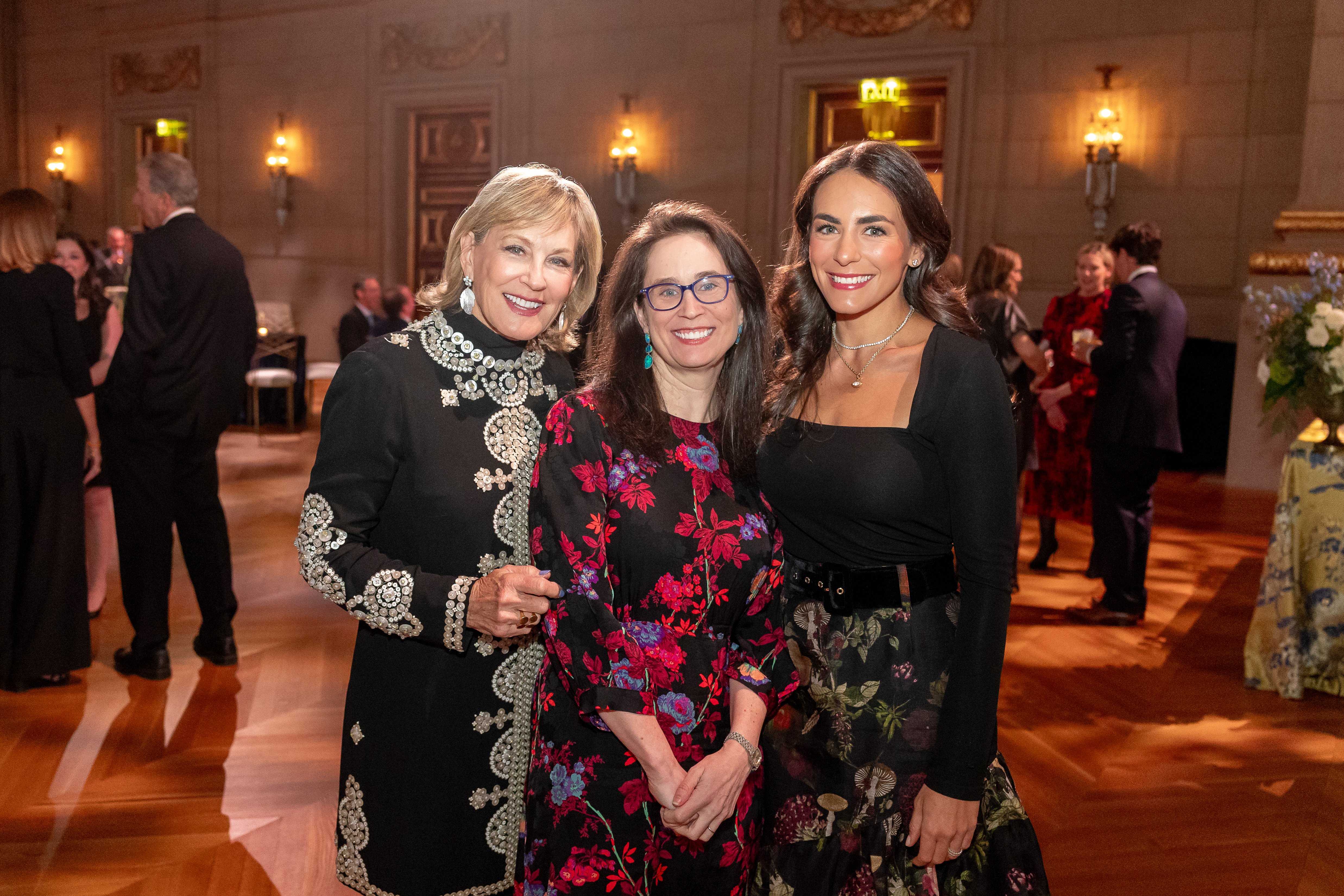 Three smiling attendees at the Trust Celebration of Gratitude event.