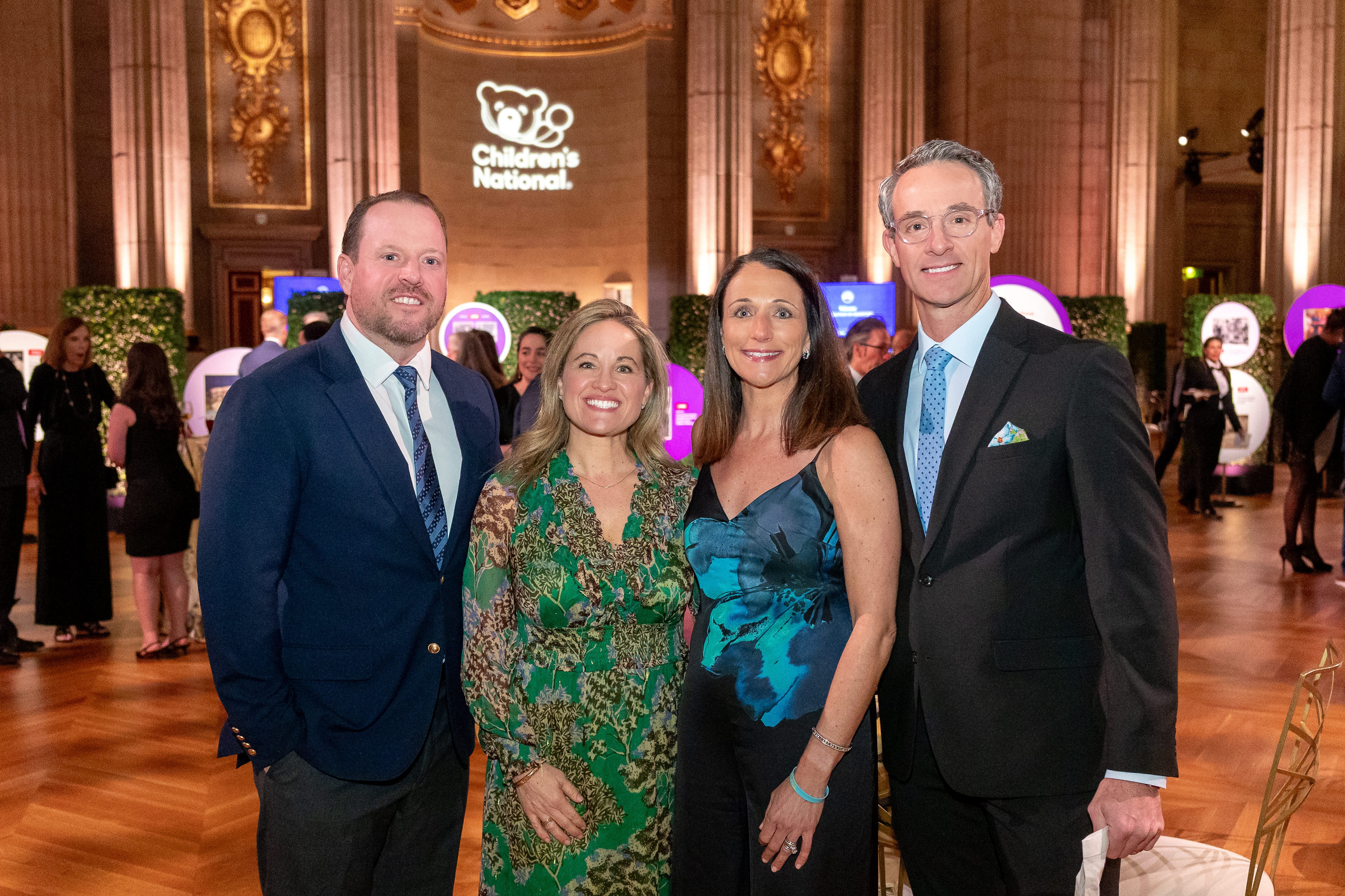 Four smiling attendees at the Trust Celebration of Gratitude event.