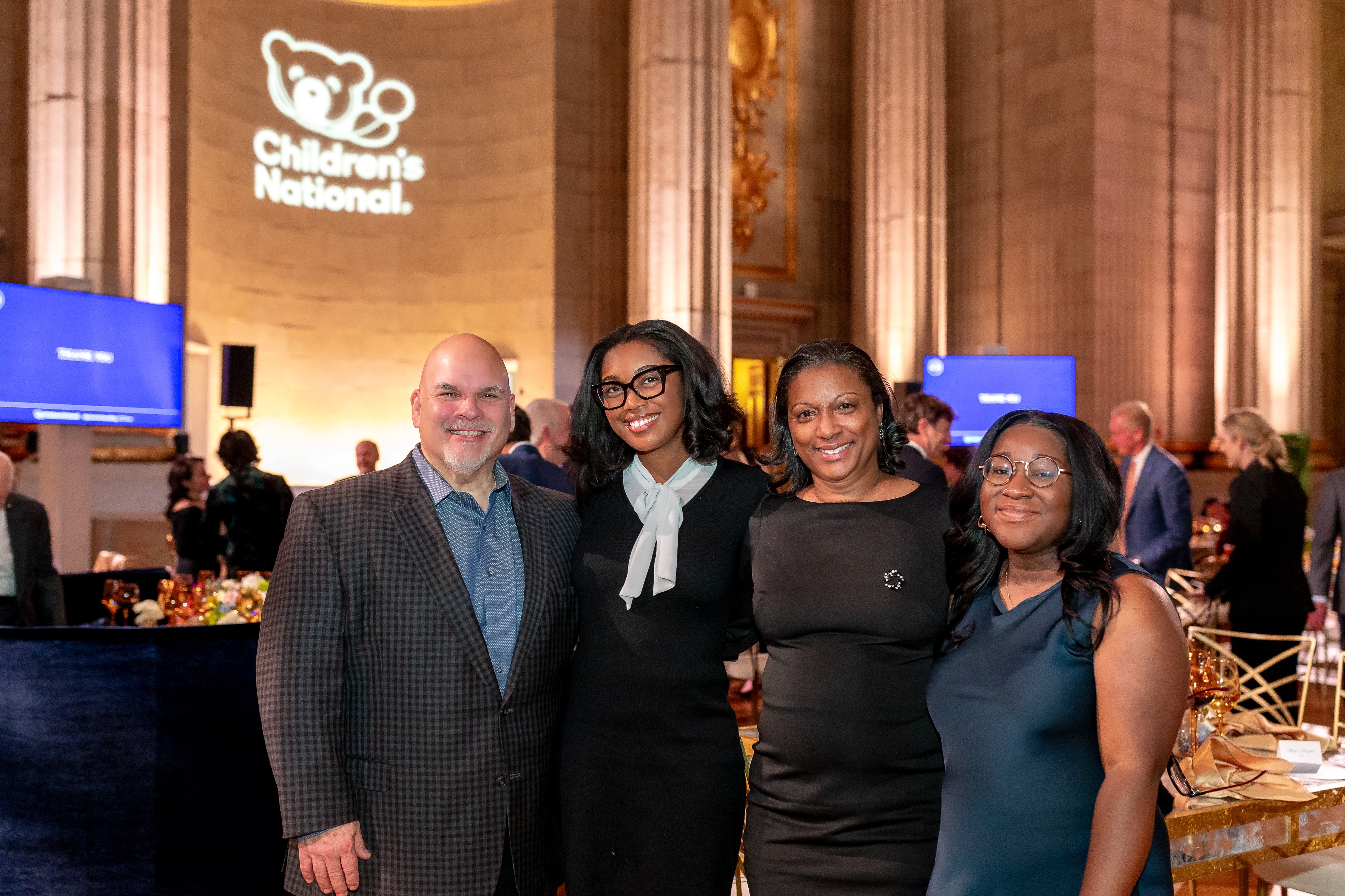 Four smiling attendees at the Trust Celebration of Gratitude event.