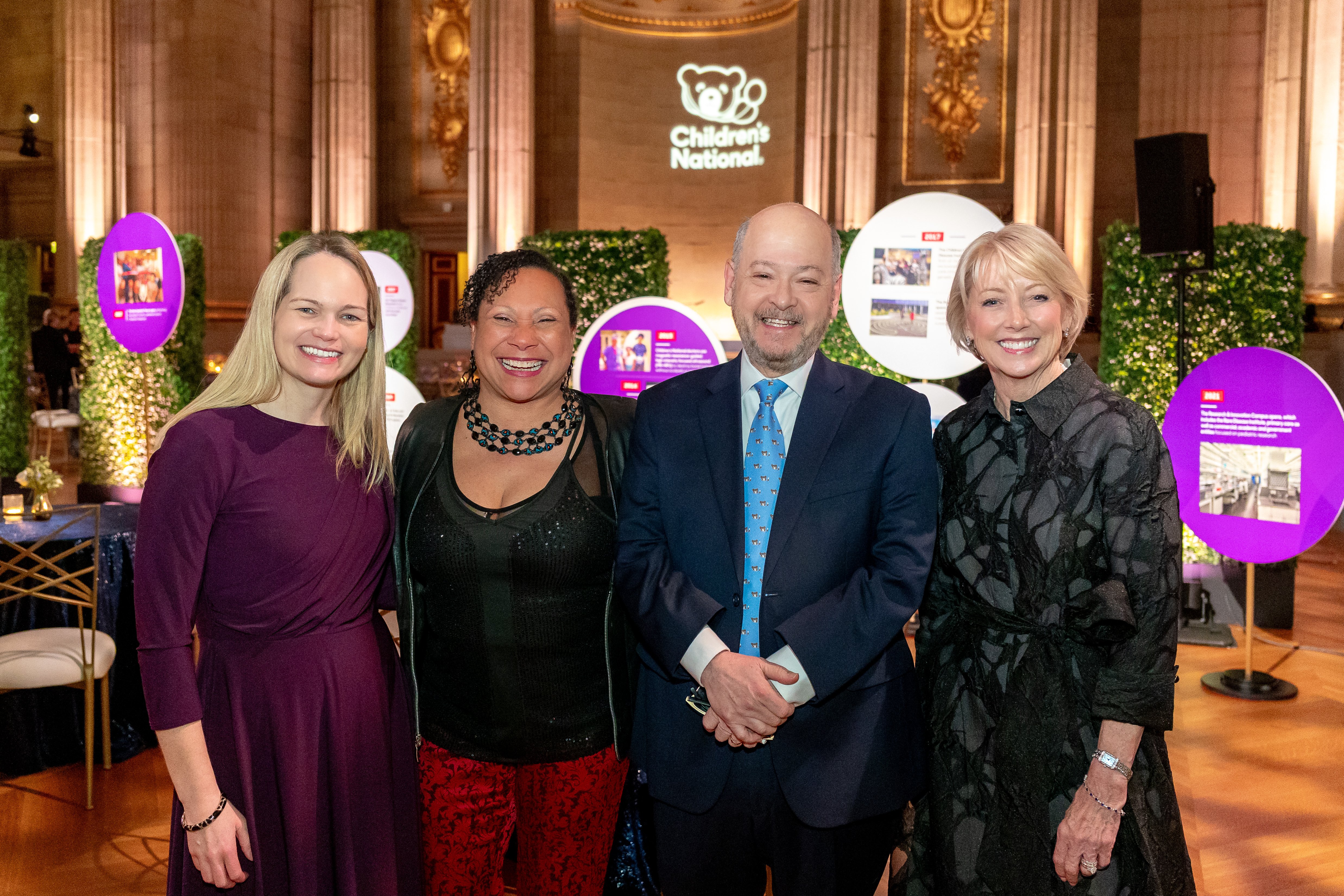Four smiling attendees at the Trust Celebration of Gratitude event.