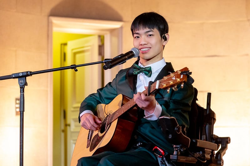 Patient ambassador, Max, plays guitar at the Trust Celebration of Gratitude event.
