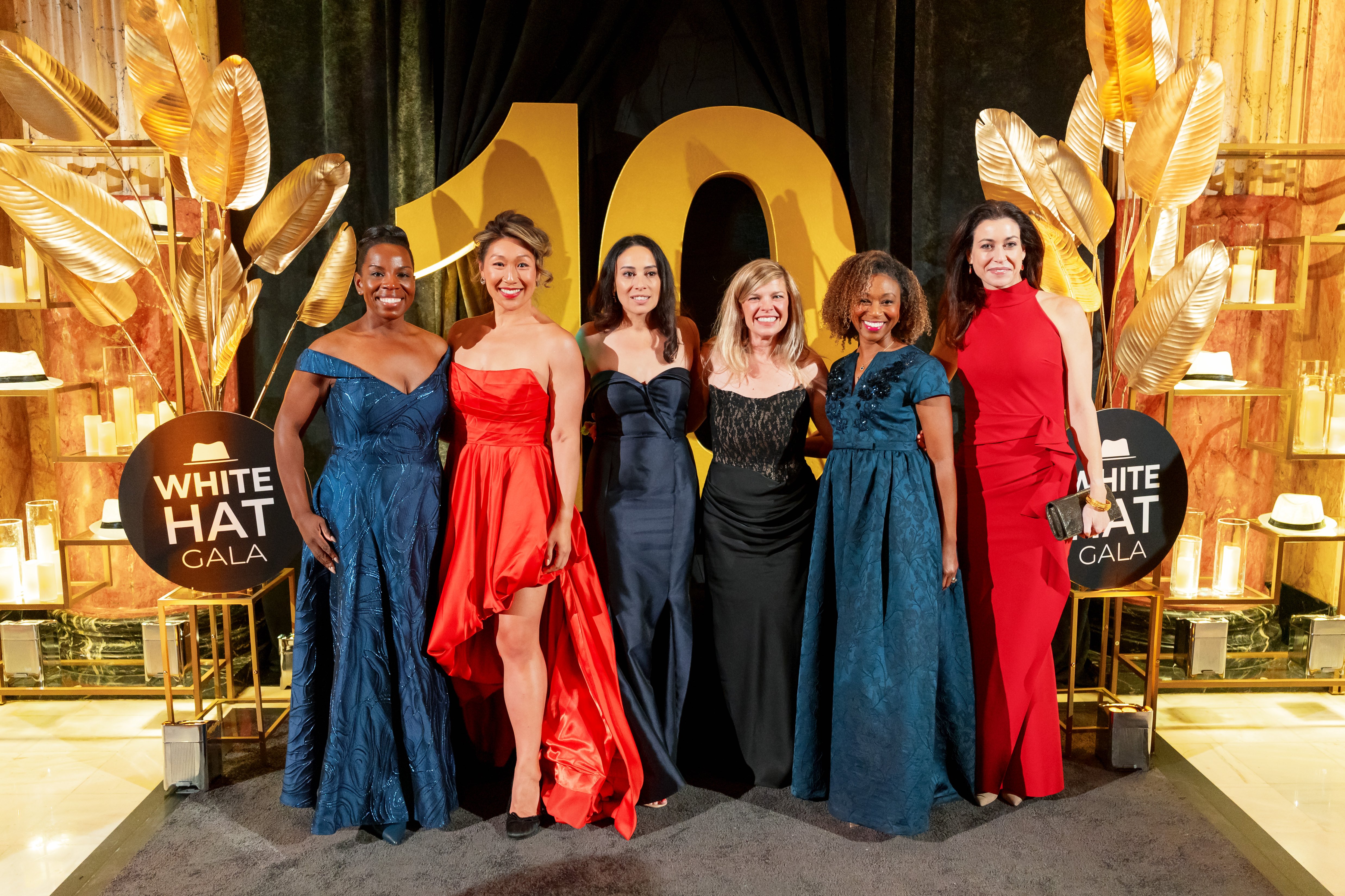 Female attendees at the White Hat Gala 2026 pose for a picture.