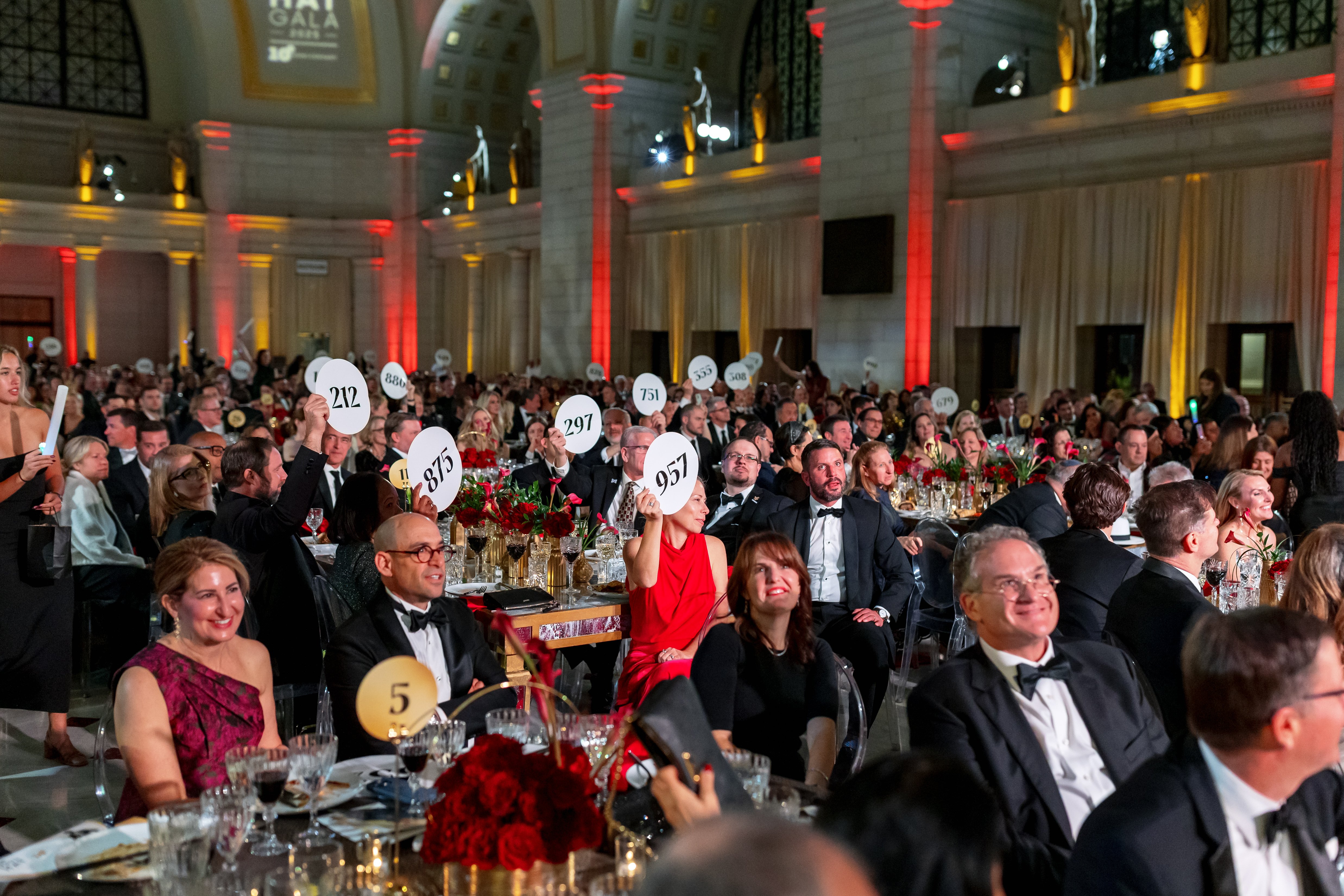 Auction participants raise bid numbers during the White Hat Gala 2026 at Union Station in Washington, D.C.