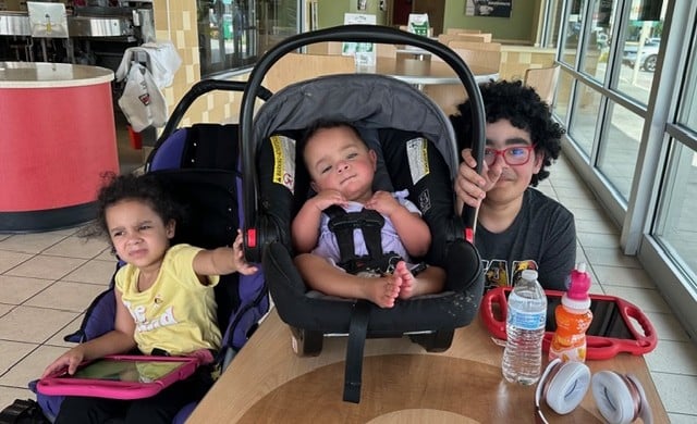Ashley's three children posing together.