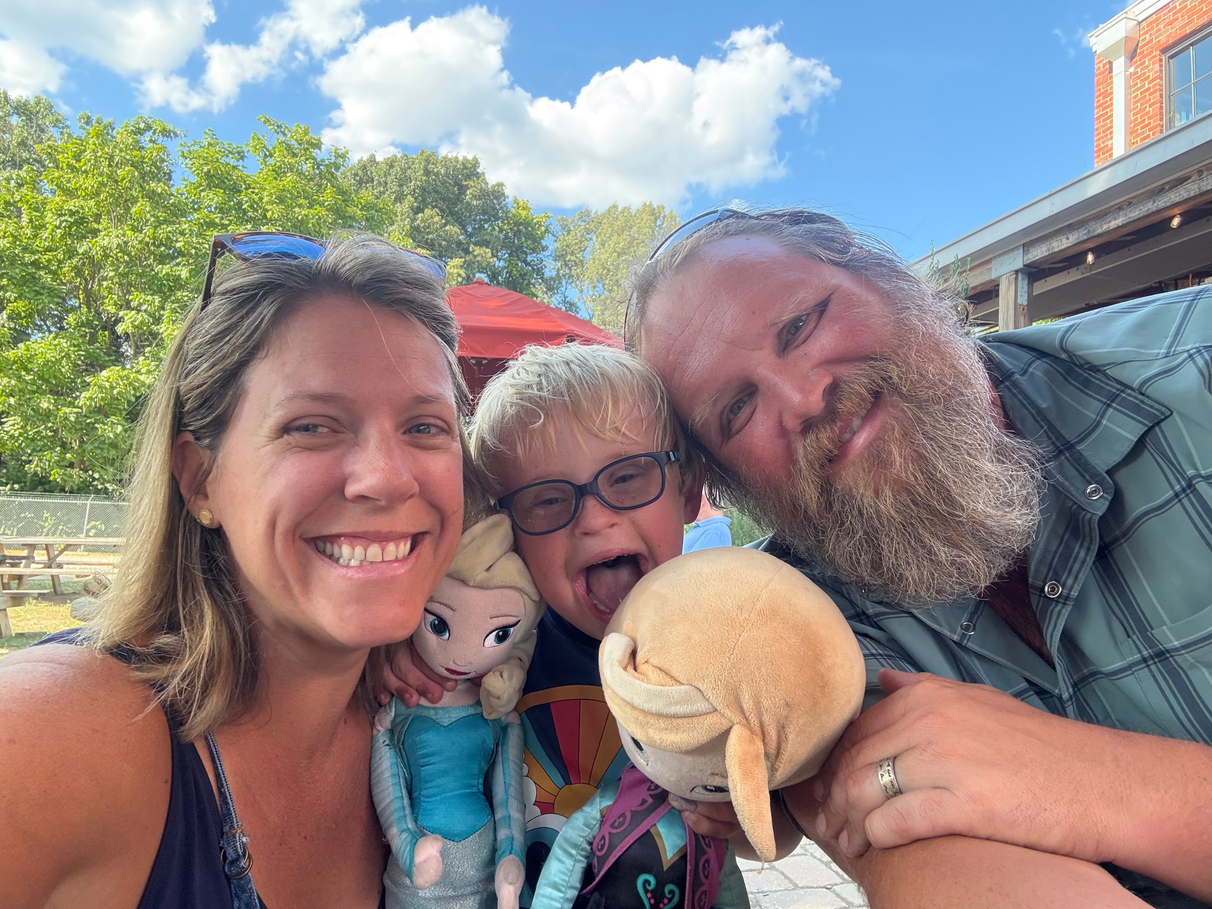 Callan smiling with his parents.