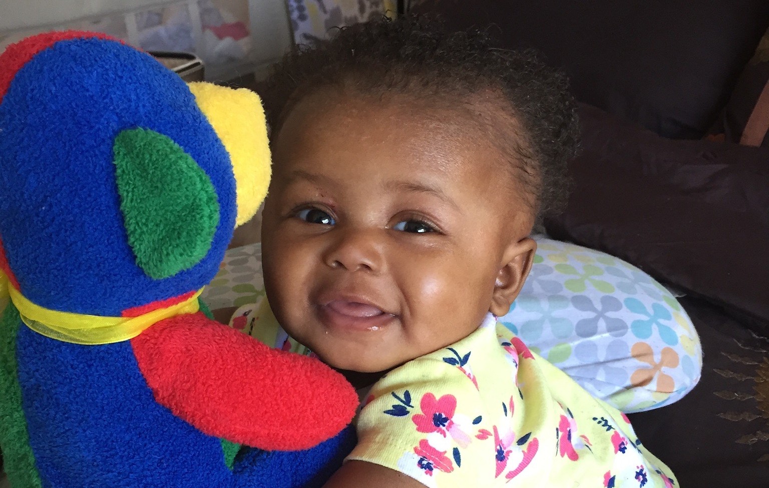 Children's National Hospital patient, Jordyn, as an infant cuddling a stuffed animal.