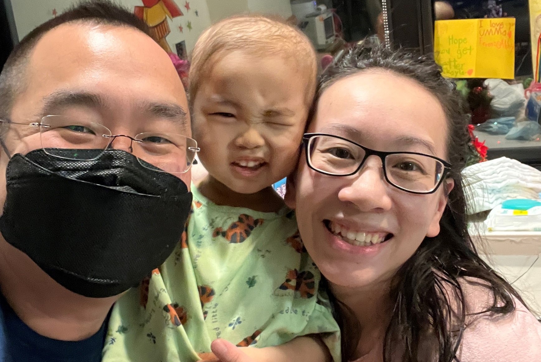 Mikaela shares a moment with her parents during her treatment at the hospital.