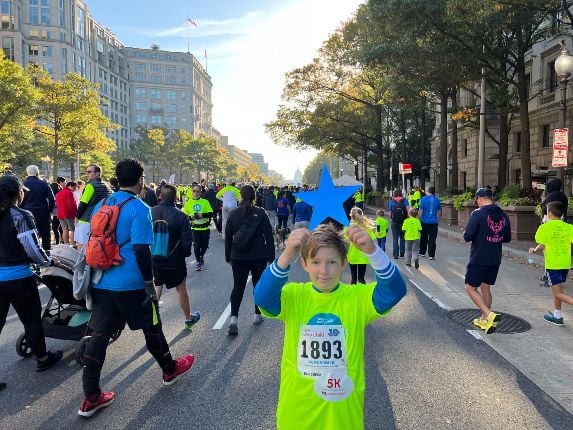 Children's National hospital patient, Sam, holds a blue star at the Race for Every Child event.