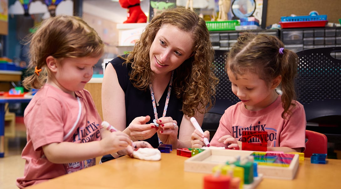 Lauren Schlenger, MA, ATR-BC, LPC, art therapist, with patients in the Tracy's Kids art therapy studio.