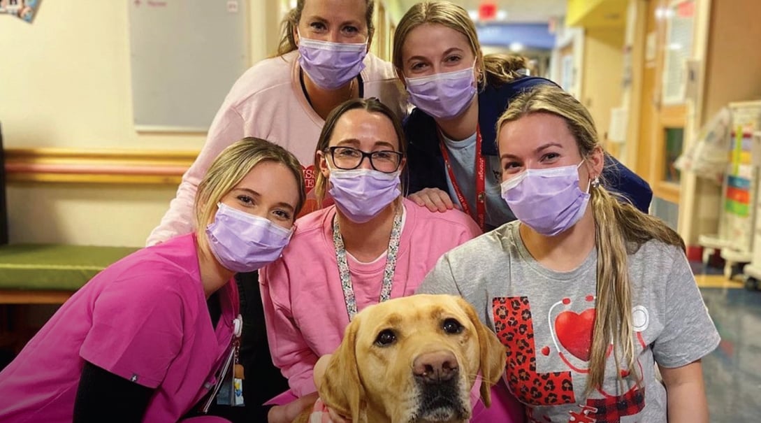 Amelia Dome with fellow nurses and one of Children's National Hospital's facility dogs.