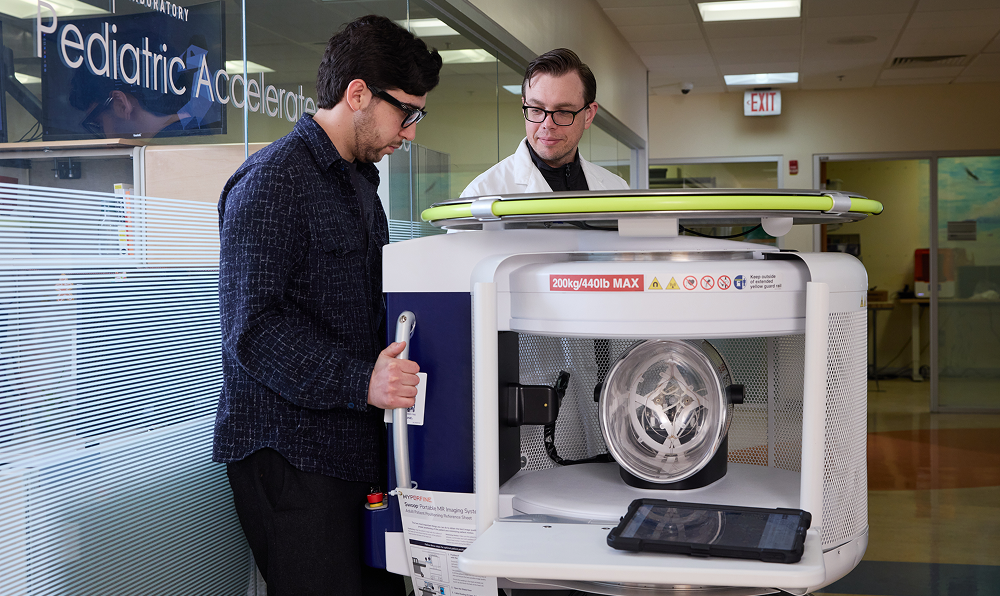 Drs. Linguraru and Donoho moving the Hyperfine Swoop at the Sheikh Zayed Institute for Pediatric Surgical Innovation.