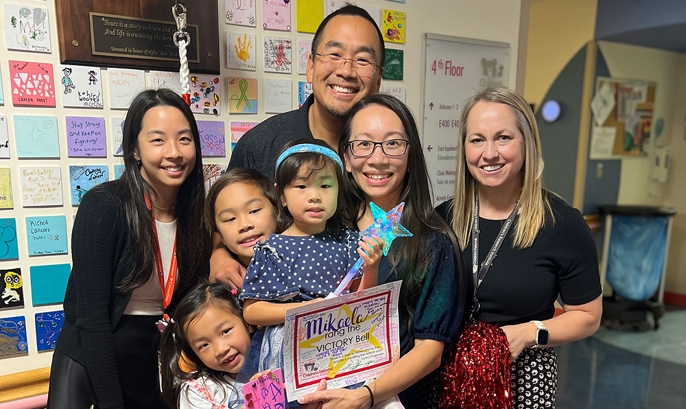 Mikaela celebrates ringing the victory bell with her family, alongside Drs. Jennifer Wang and Dr. Bollard reviews lab findings Keri Toner.