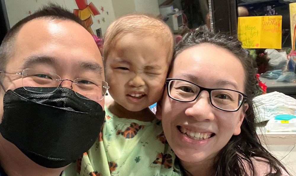 Mikaela shares a moment with her parents during her treatment at the hospital.
