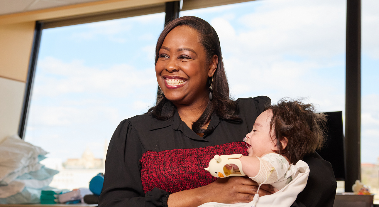 Dr. Cicely "CC" Brooks holds a NICU patient.