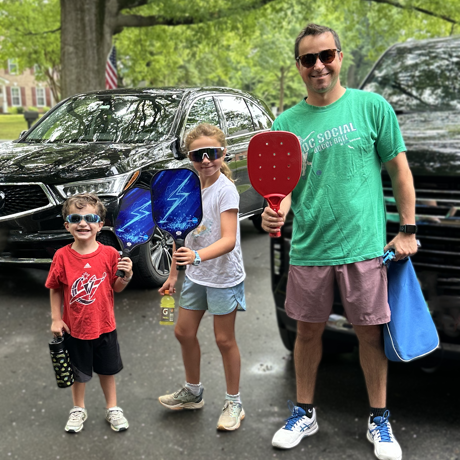 Dad with John and his sister holding pickleball rackets
