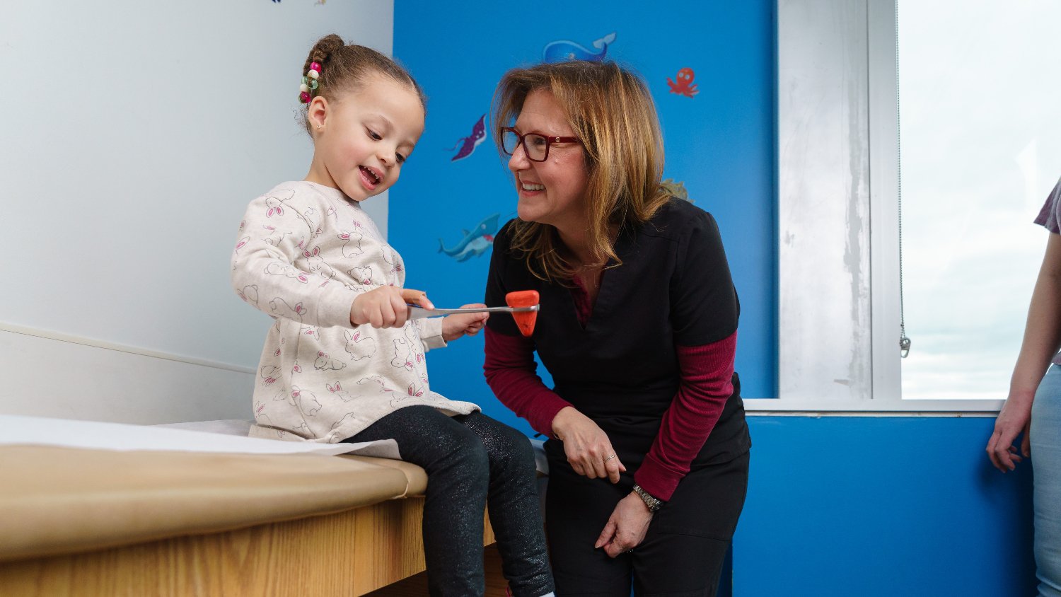 smiling little girl and doctor