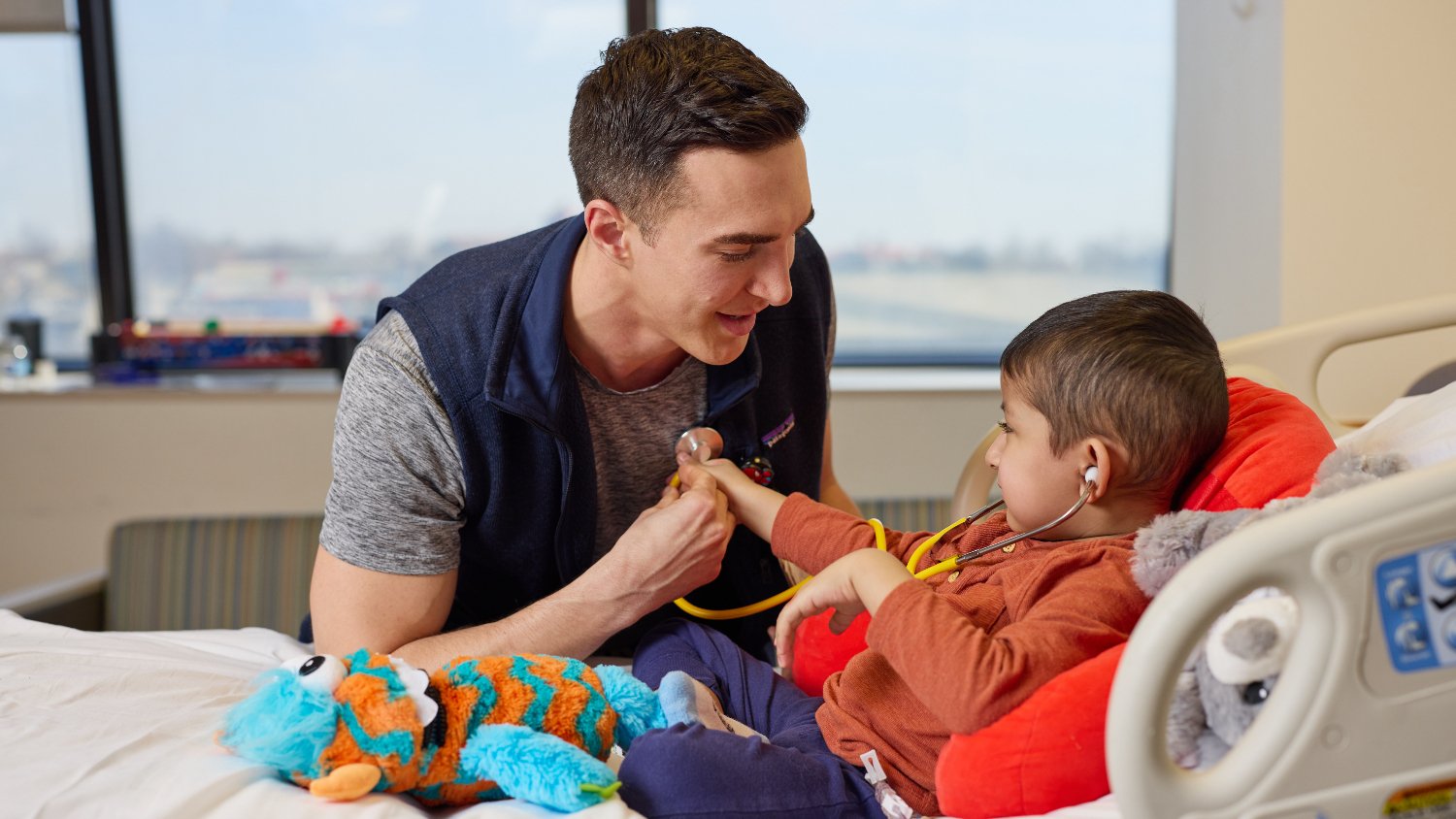 baby listens to provider's heart with stethoscope