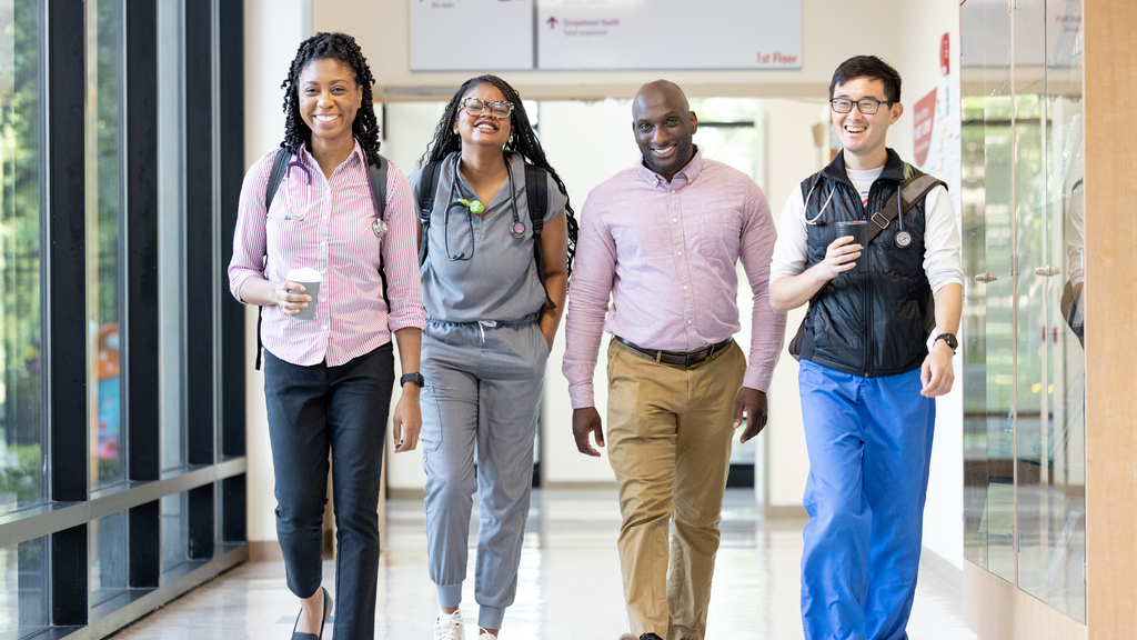 providers smiling walking down hallway