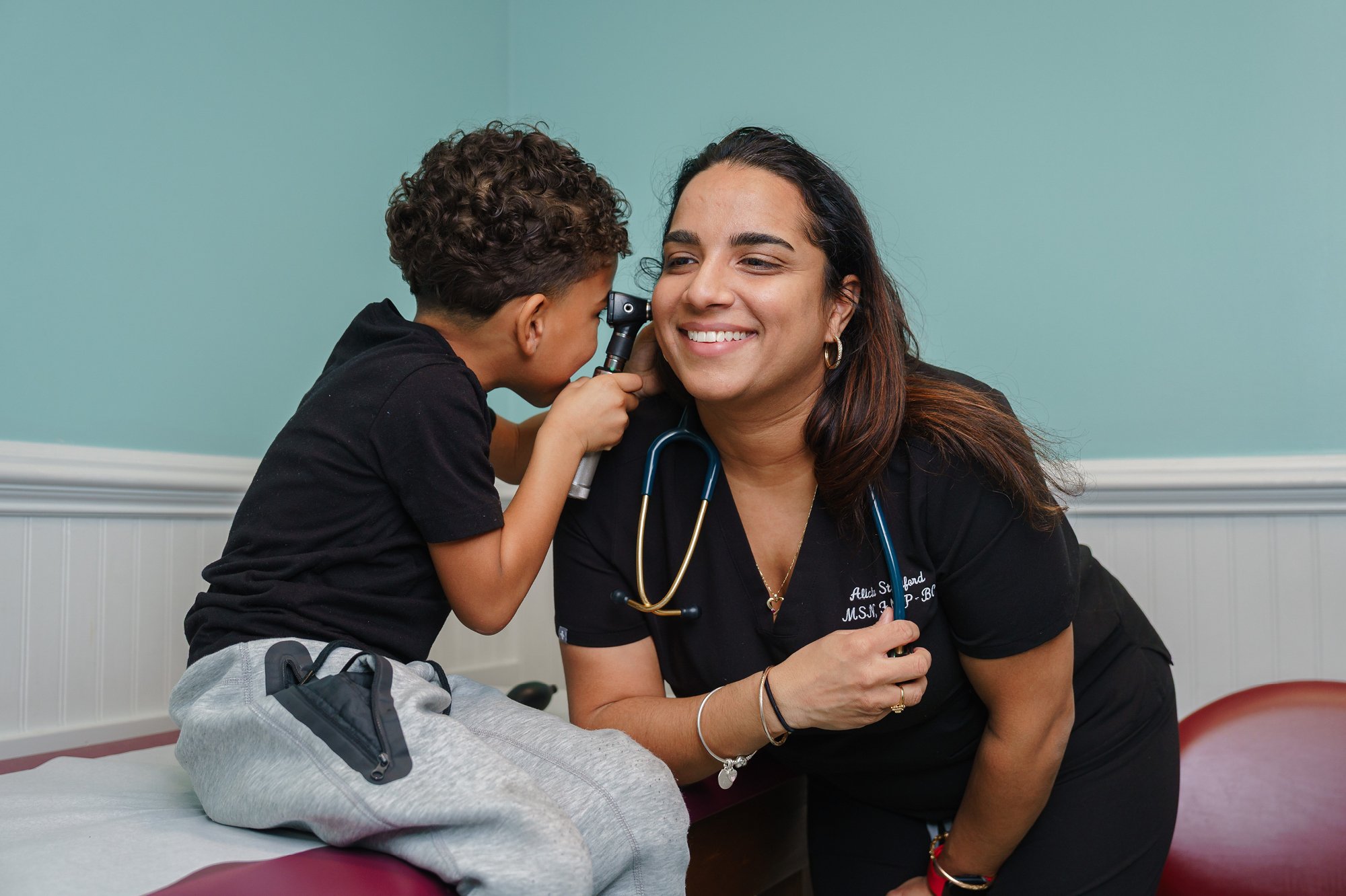 child examines healthcare provider in doctor's office