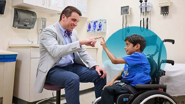 Provider with a patient seated in a wheelchair touch fingertips