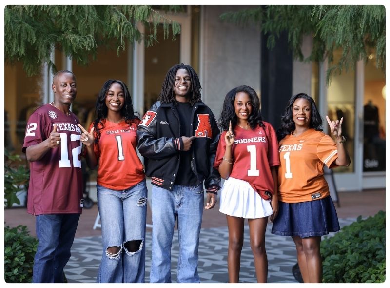 Five individuals stand together wearing Texas sports teams apparel