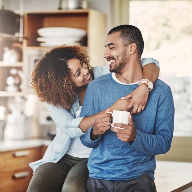 Young happy couple in kitchen