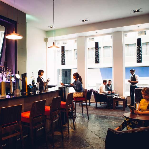 People in a restaurant  with a bar