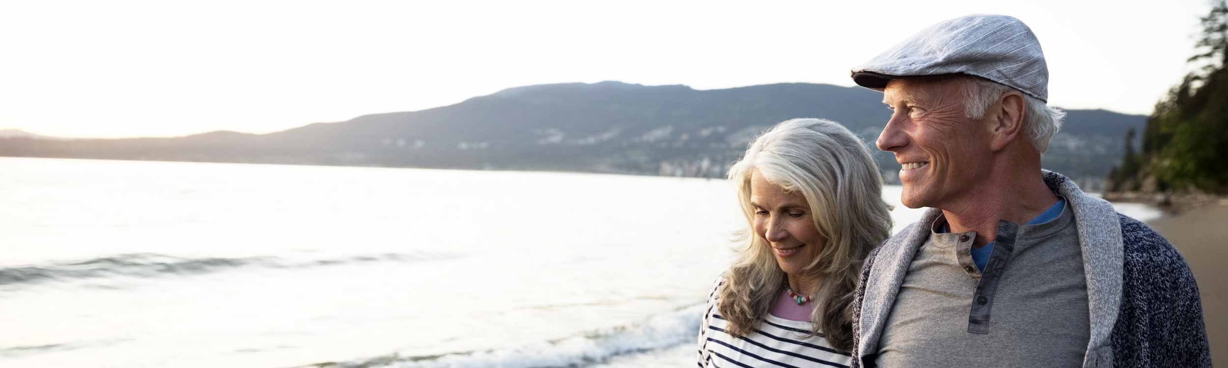 Senior couple walking along the beach
