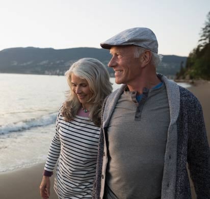 Senior couple walking along the beach