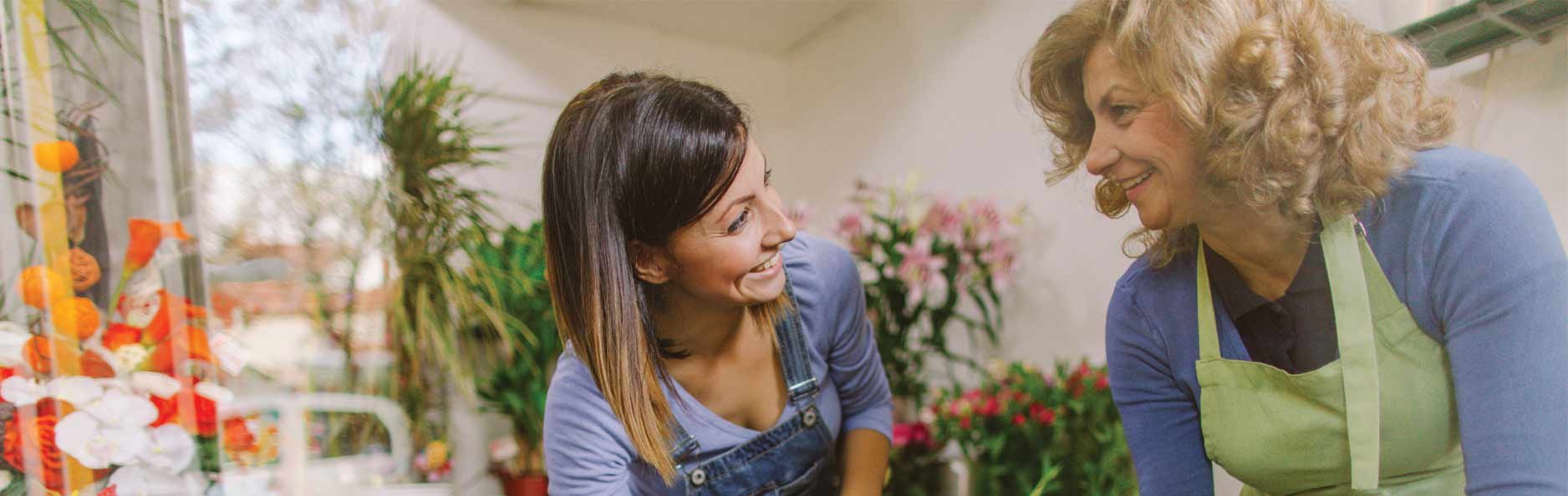 Mother and daughter florists taking care of plants