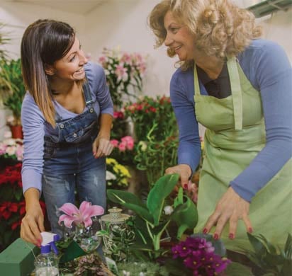 Mother and daughter florists taking care of plants