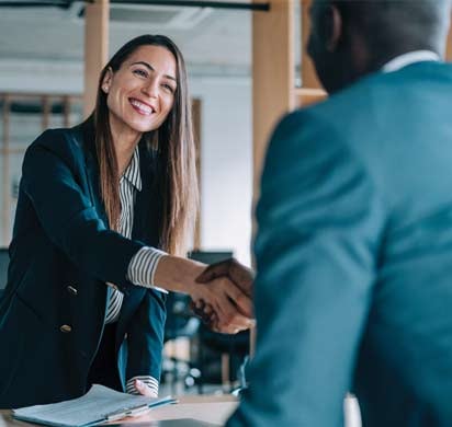 Life insurance agent shaking hands with their client