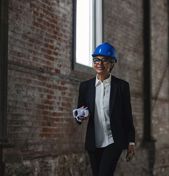 Architect on the move with blueprints