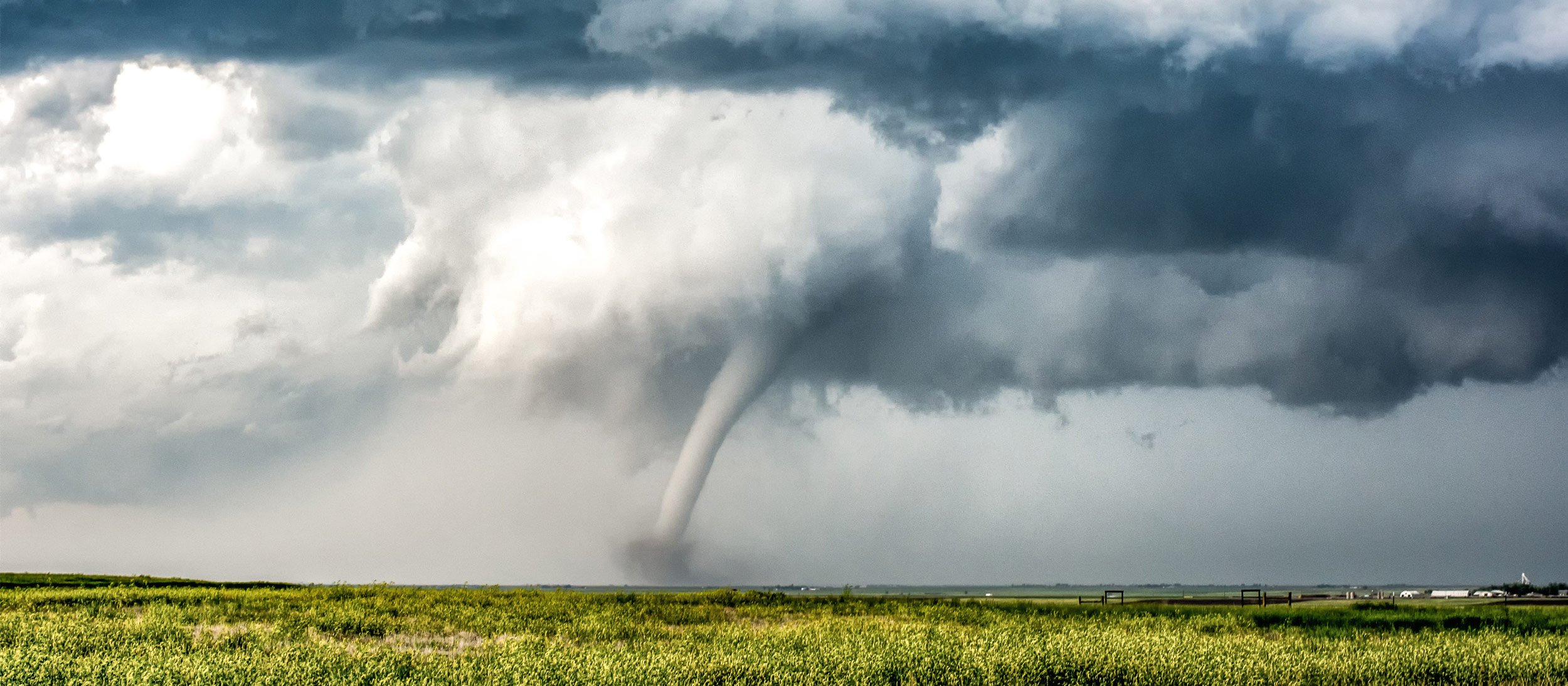 A tornado touching down on a field