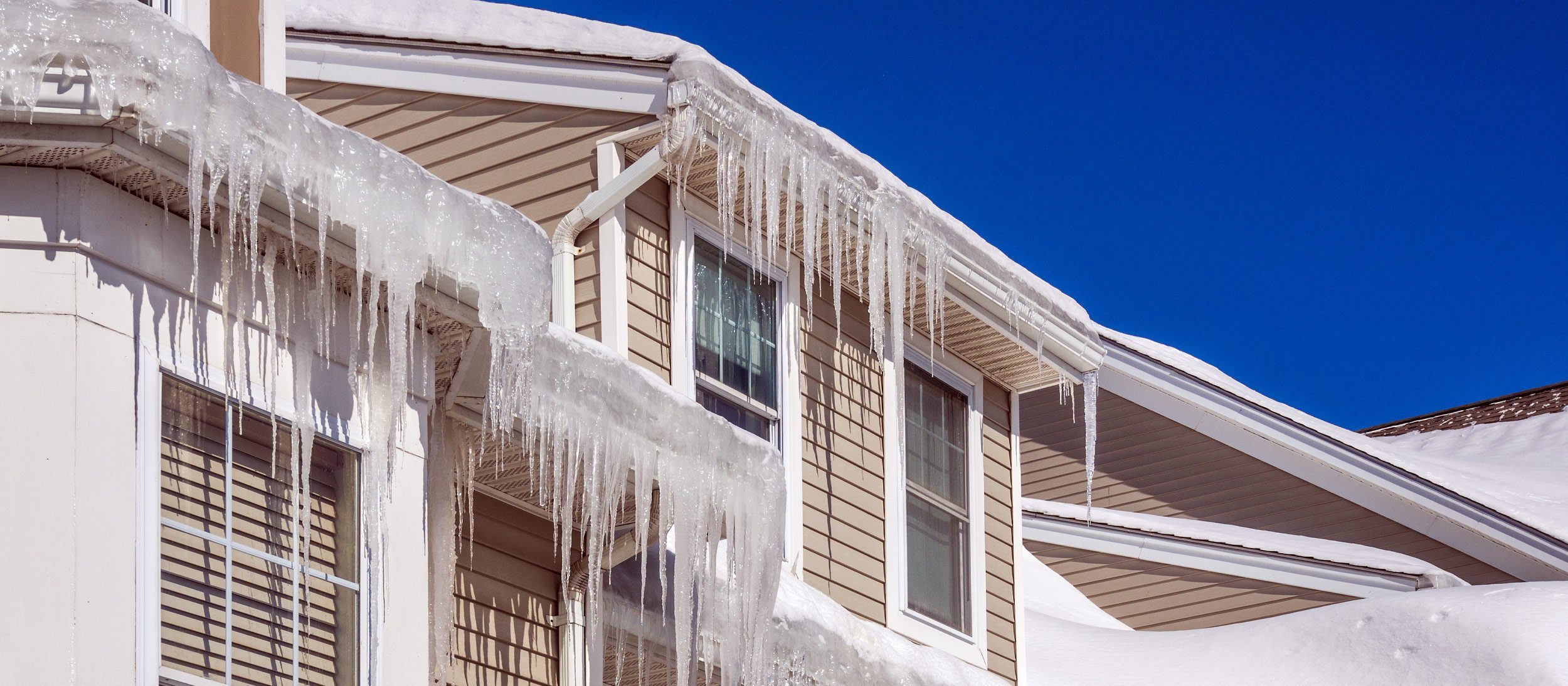Gutters of a house frozen over with icicles