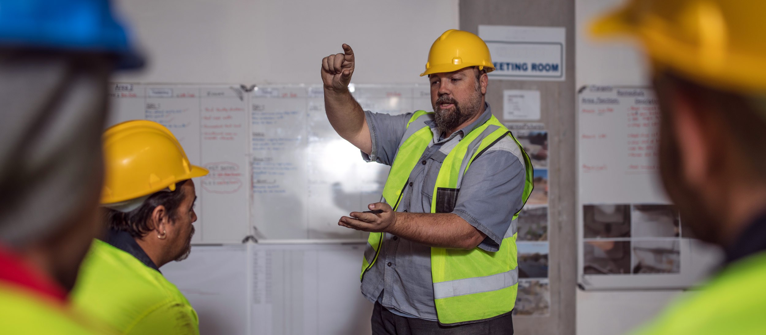 Foreman leading a meeting of contractors
