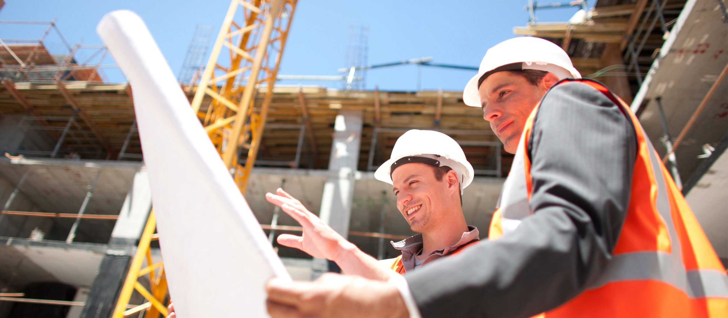 Construction workers reviewing a blueprint