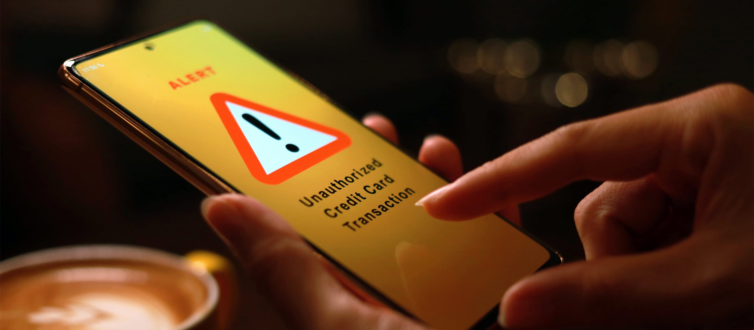 A mobile phone alerting the user of an unauthorized credit card transaction