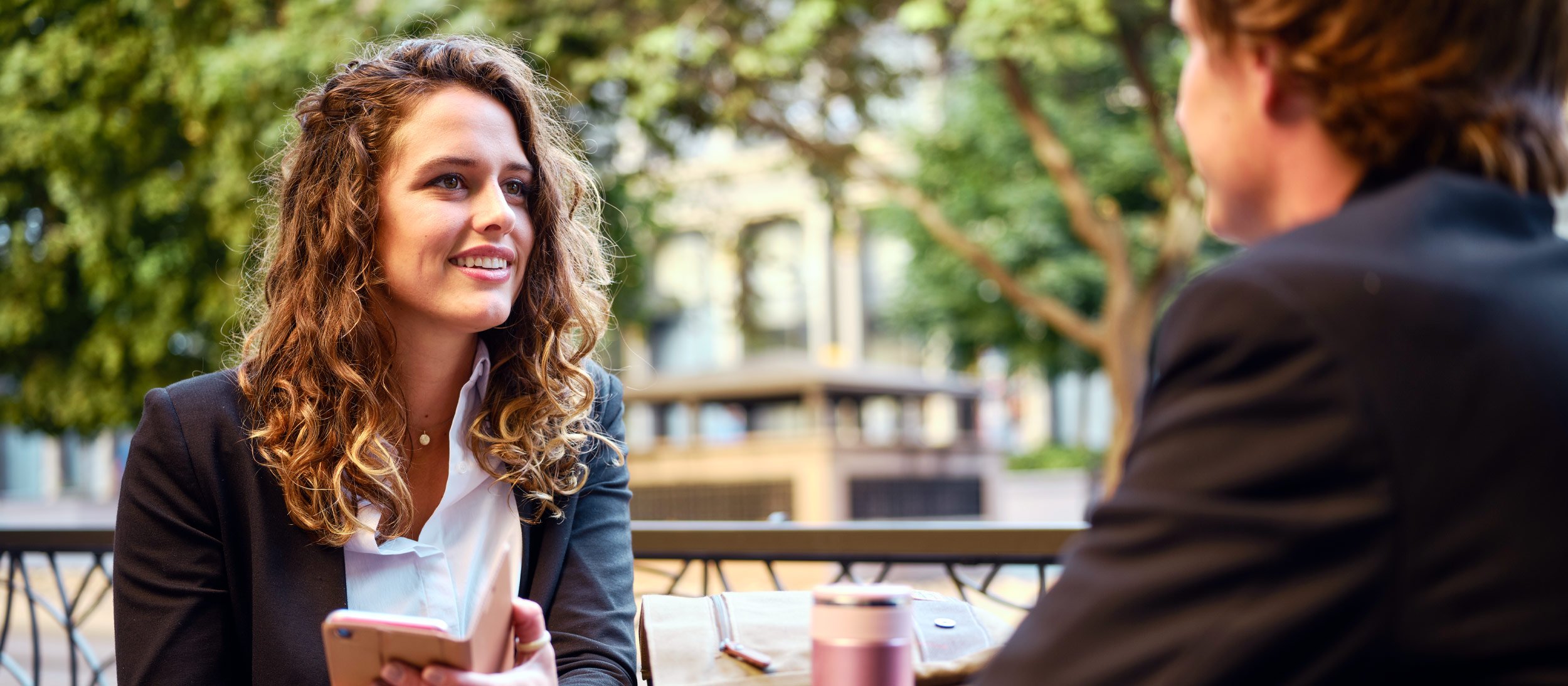 An agent having a sit down meeting outdoors with a client