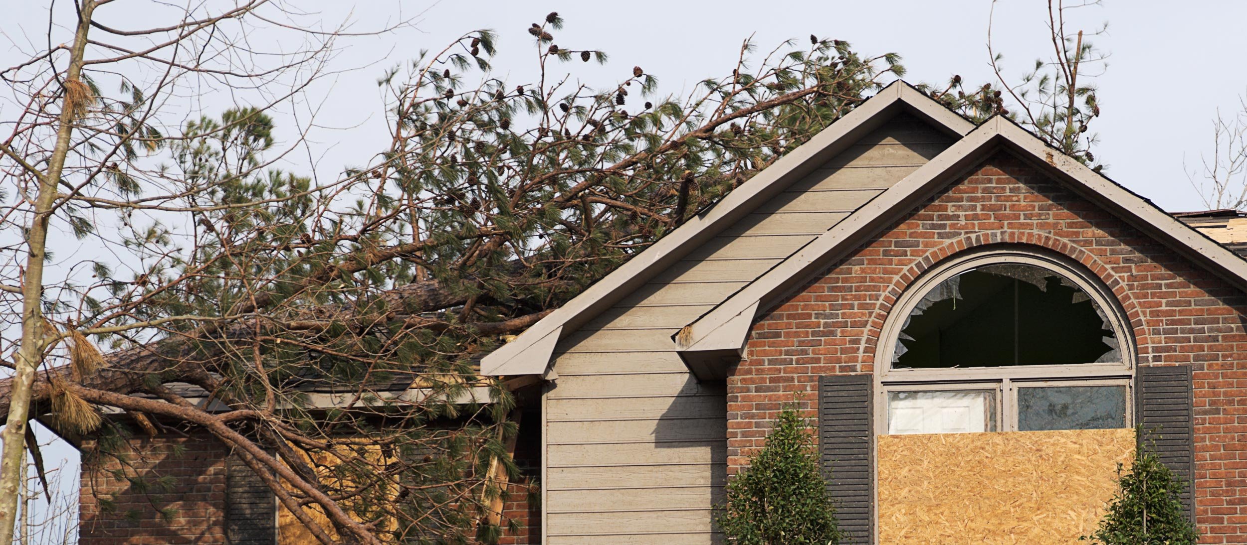 House with boarded up windows due to damage